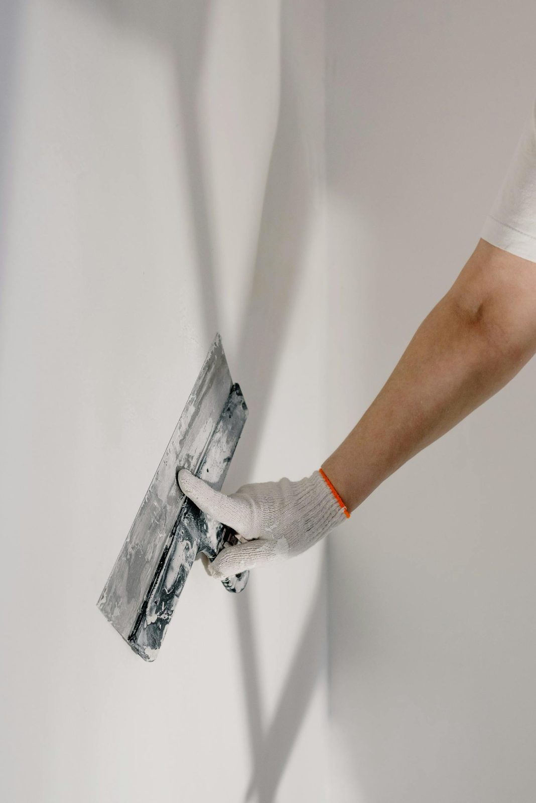 Smoothing a wall with a drywall trowel