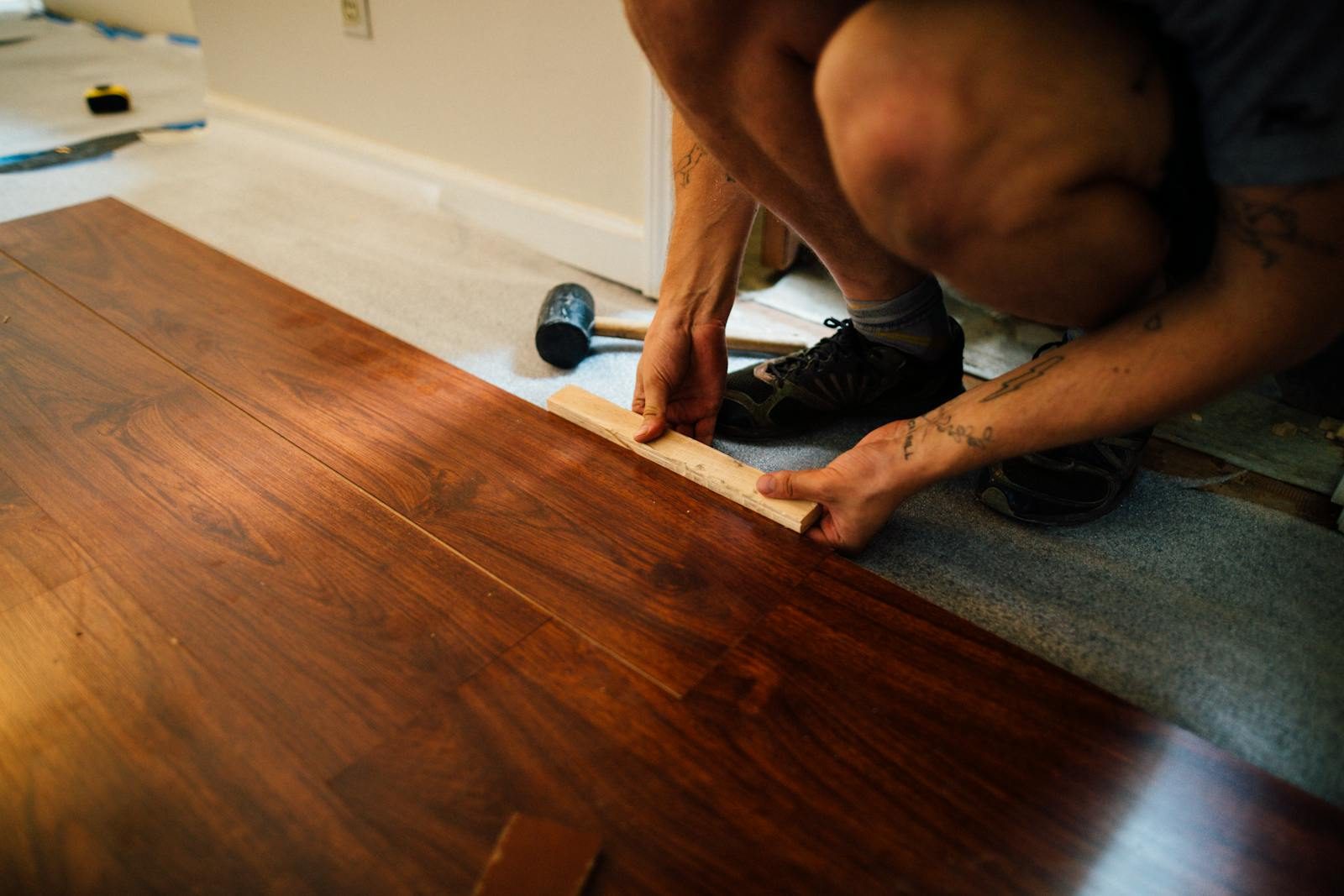 Laminate flooring being installed plank by plank